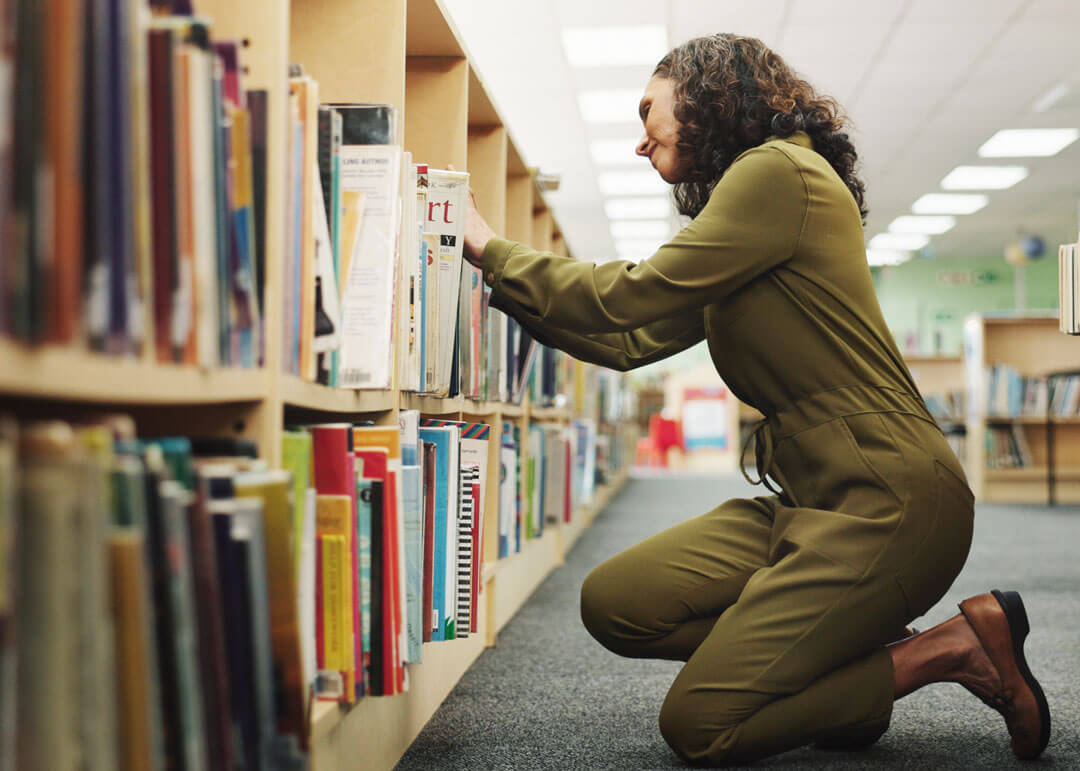 Librarion looking through books.