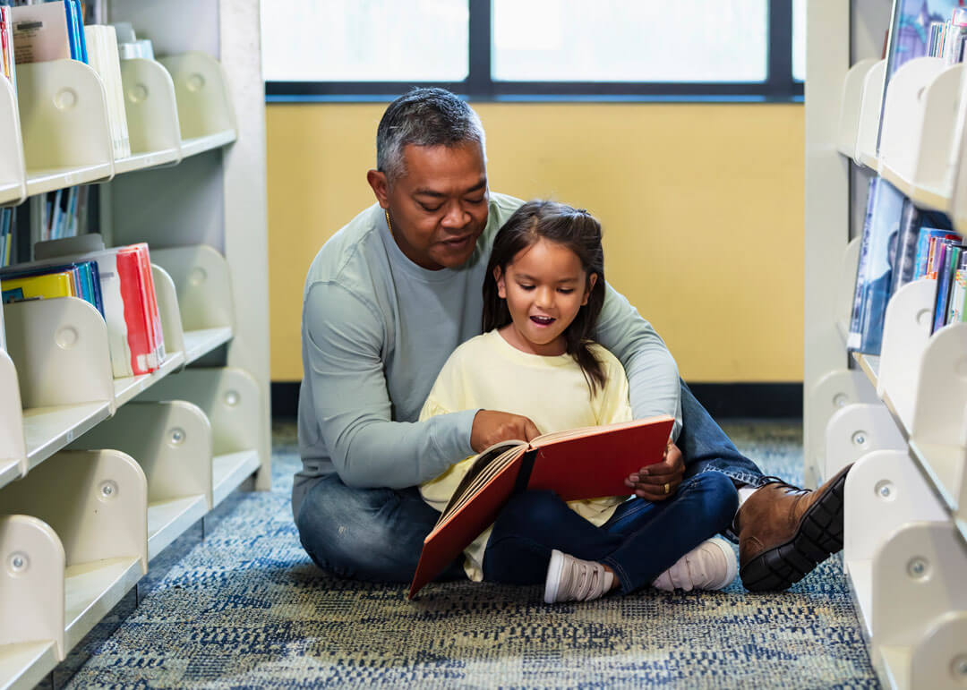 Adult man and child reading together